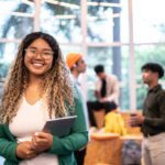 young student woman holding a digital tablet at university