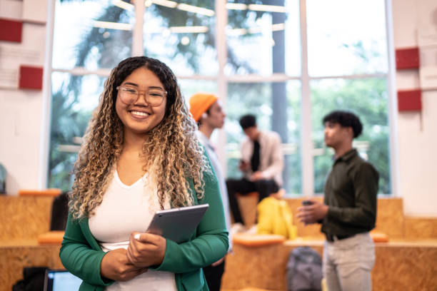 young student woman holding a digital tablet at university