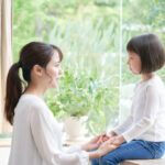 Asian mother making promise with daughter