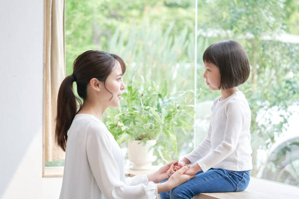 Asian mother making promise with daughter